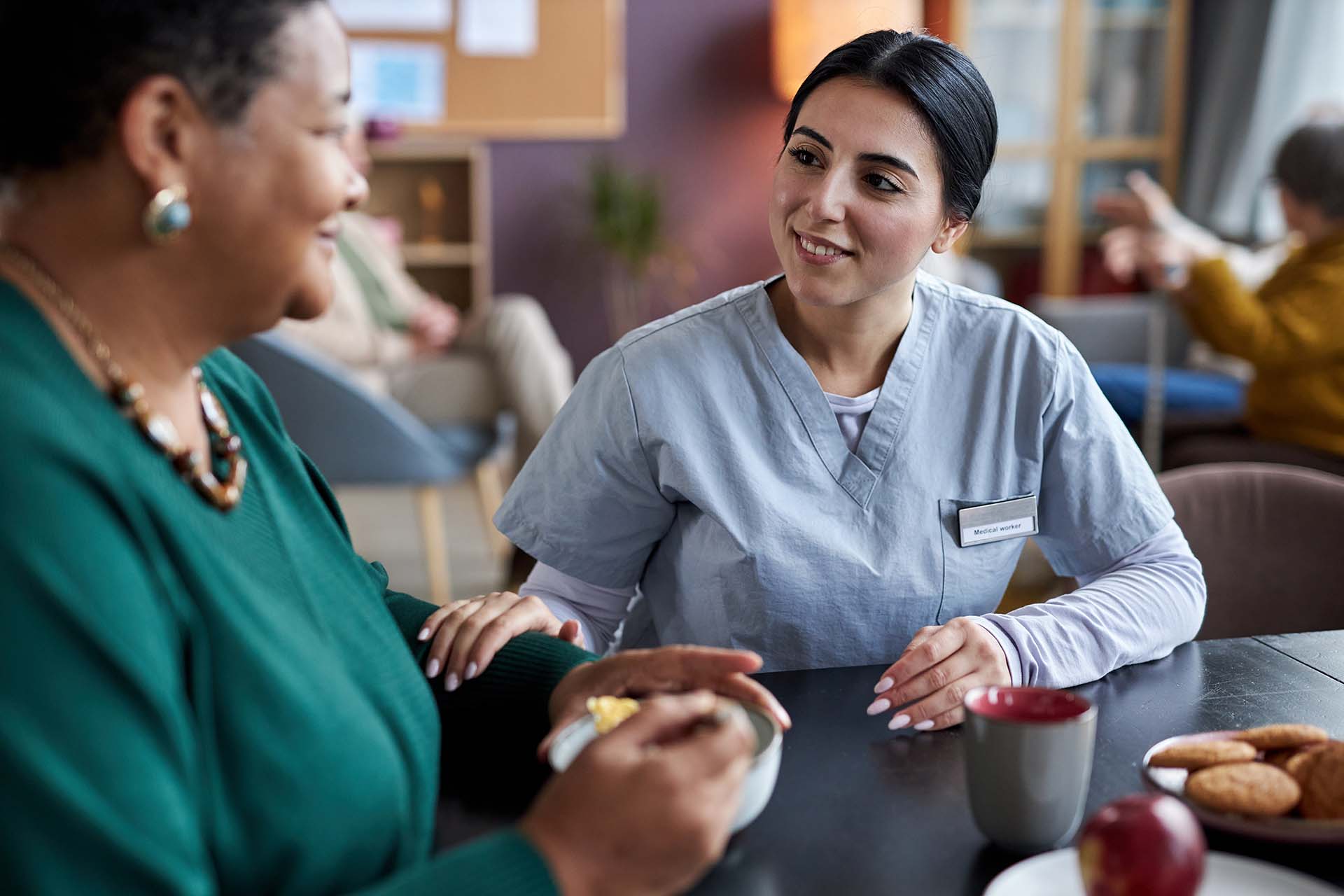 young-caring-nurse-talking-senior-woman-retirement-home.jpg